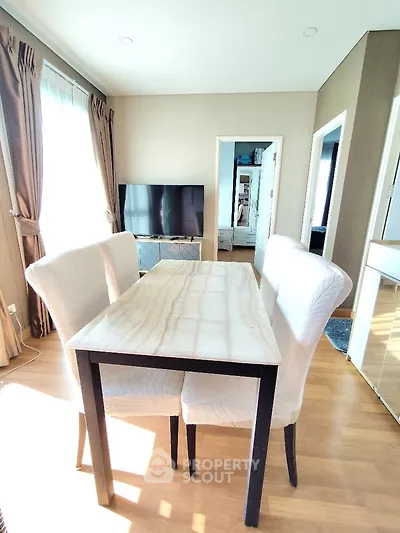Bright dining area with elegant table and chairs, perfect for modern living.