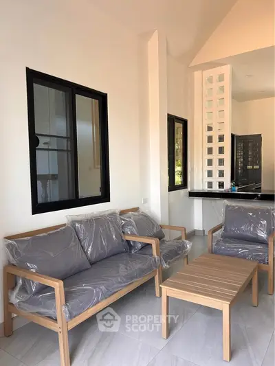 Modern living room with sleek furniture and large windows in a stylish home.