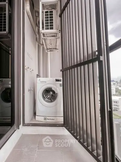 Compact balcony with washing machine and city view, ideal for urban living.