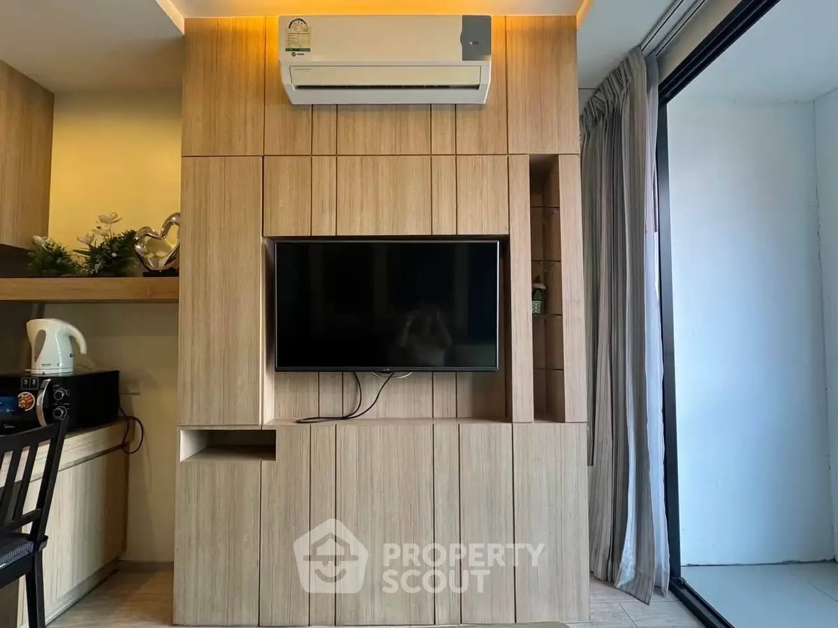 Modern living room with built-in wooden TV cabinet and air conditioning unit.