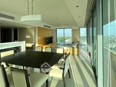 Luxurious modern living room with panoramic city view and elegant dining area.