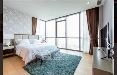 Luxurious modern bedroom with large windows and elegant decor