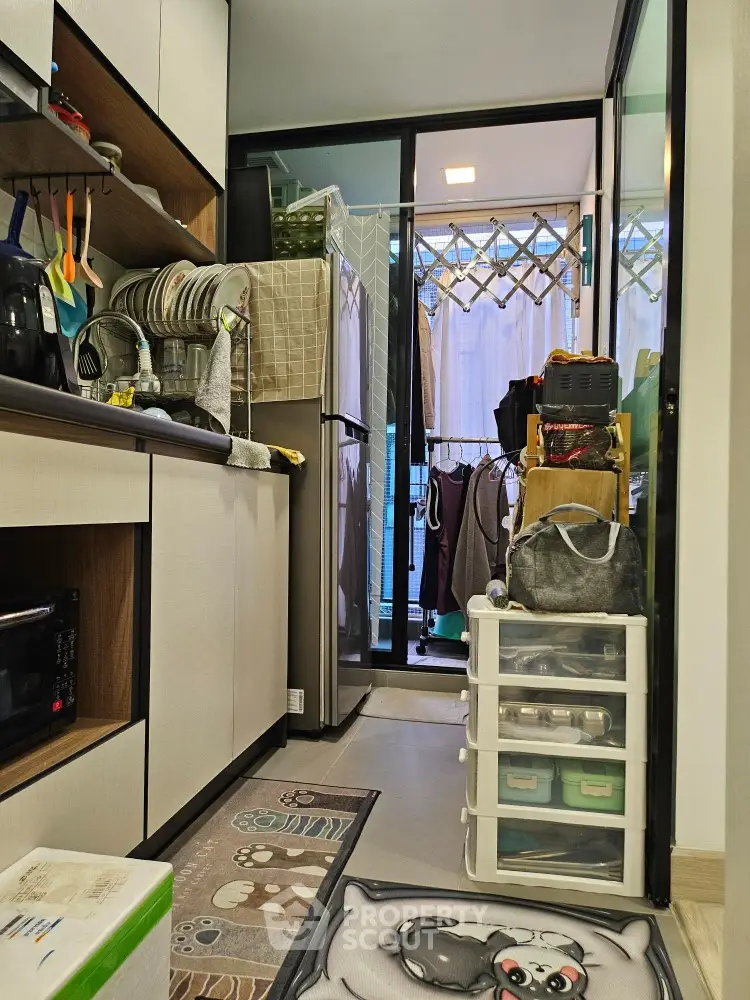 Compact kitchen with modern appliances and balcony access