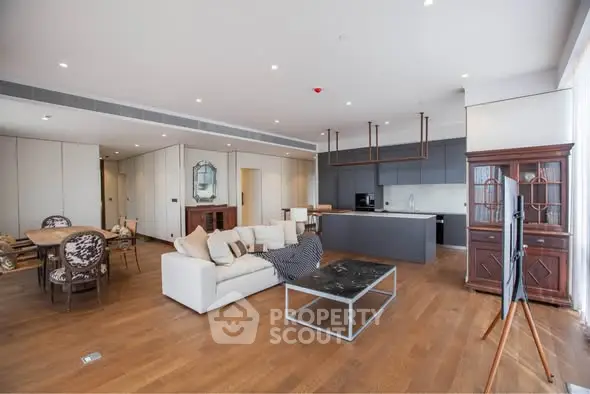 Spacious open-plan living room with modern kitchen and elegant dining area.