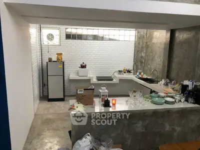 Modern industrial kitchen with concrete countertops and minimalist design.