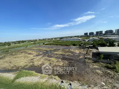 Expansive land plot with potential for development, offering scenic views and strategic location near urban amenities.