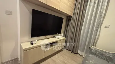 Modern living room with sleek TV setup and stylish cabinetry