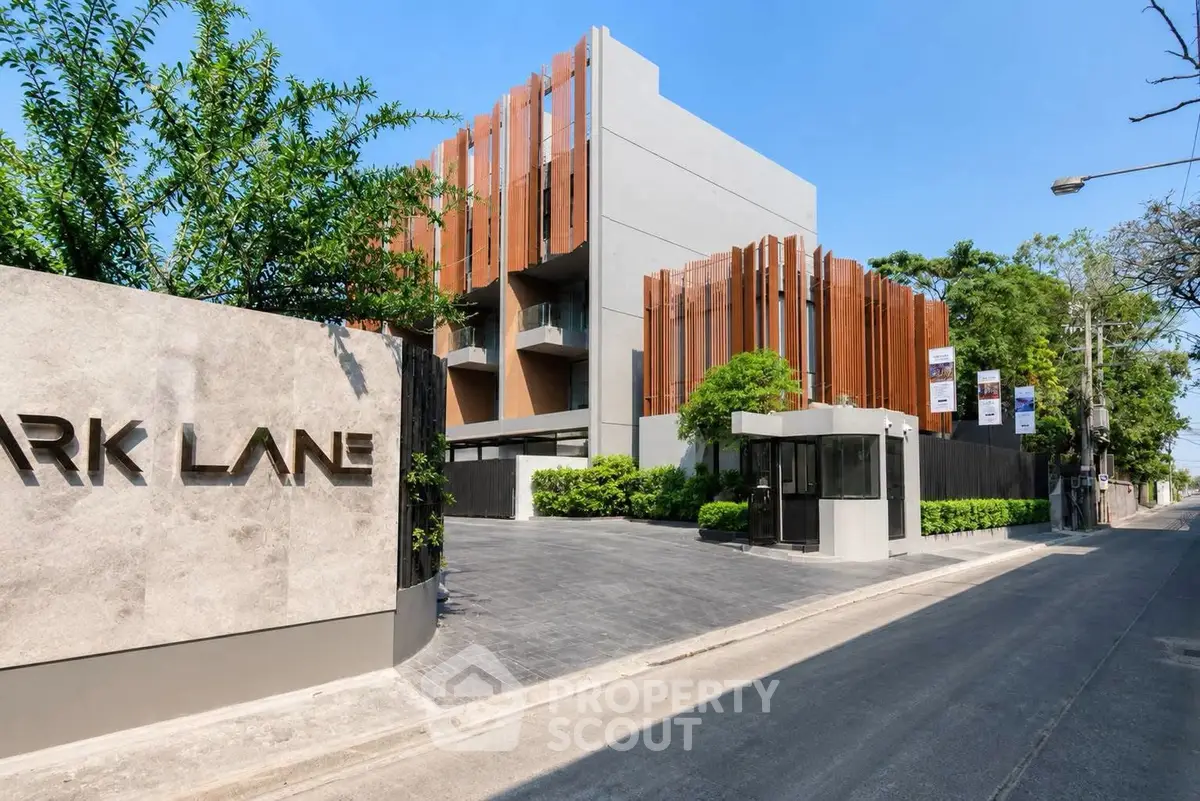 Modern building exterior with unique architectural design and lush greenery in a prime location.