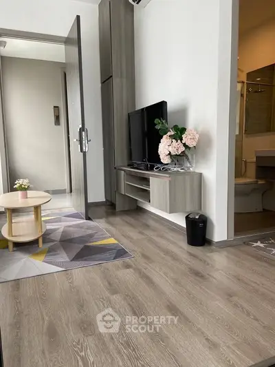 Modern living room with sleek wooden flooring and stylish decor