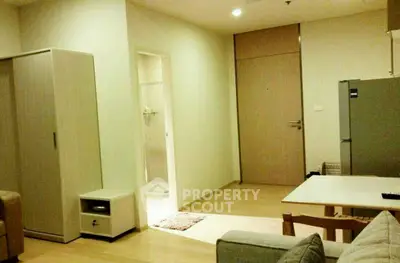 Modern apartment interior with cozy living area and sleek kitchen design.