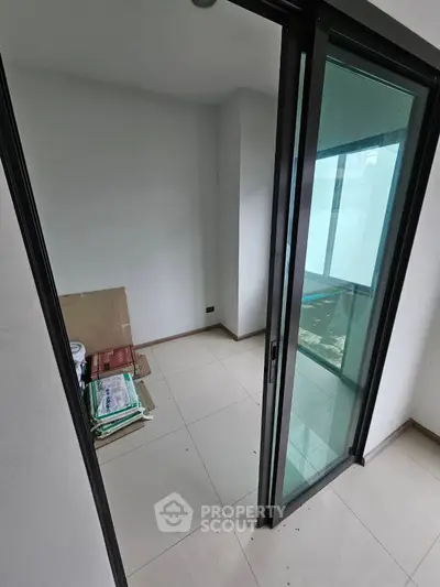 Compact storage room with sliding glass door and tiled floor