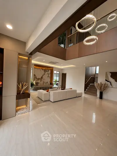 Luxurious modern living room with high ceilings and elegant lighting fixtures