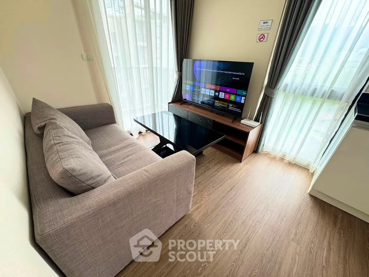 Cozy living room with modern TV setup and natural light