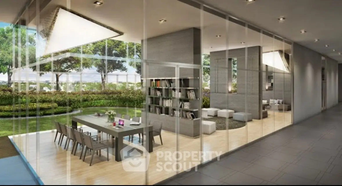 Modern open-concept living and dining area with glass walls and garden view.