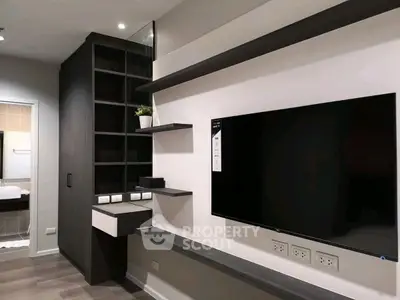 Modern living room with sleek TV setup and stylish shelving