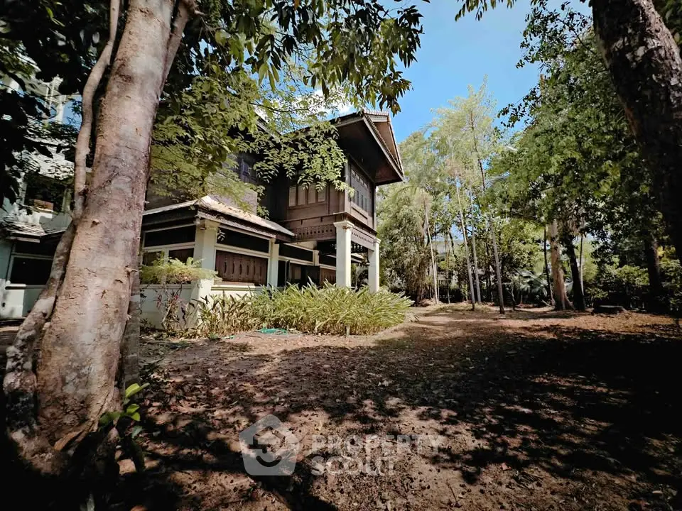 Charming rustic house surrounded by lush greenery and trees, offering serene natural views and tranquility.