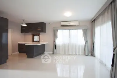 Spacious modern living room with open kitchen and large windows
