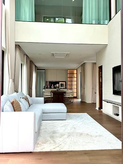Luxurious modern living room with high ceiling and elegant decor