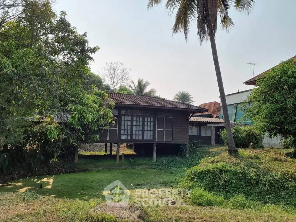 Charming stilt house with lush greenery and serene surroundings, perfect for nature lovers seeking tranquility.