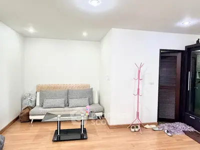 Cozy living room with modern sofa and sleek coffee table, perfect for relaxation.