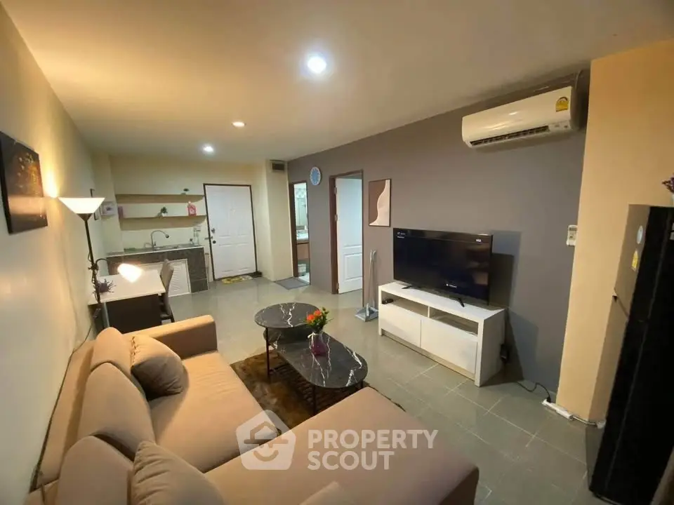 Spacious living room with modern decor and open kitchen layout