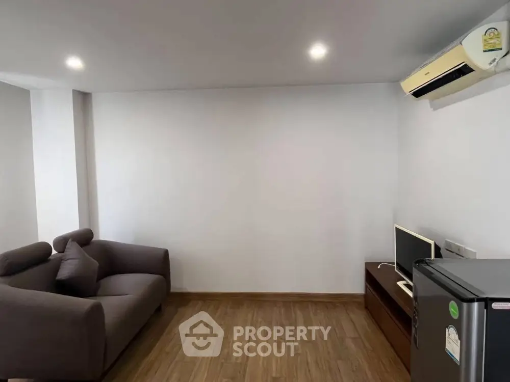 Modern minimalist living room with sleek furniture and air conditioning