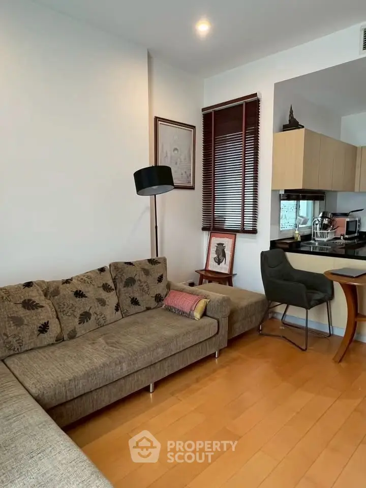 Cozy living room with modern decor and open kitchen layout, perfect for urban living.