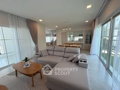 Spacious modern living room with large windows and elegant decor