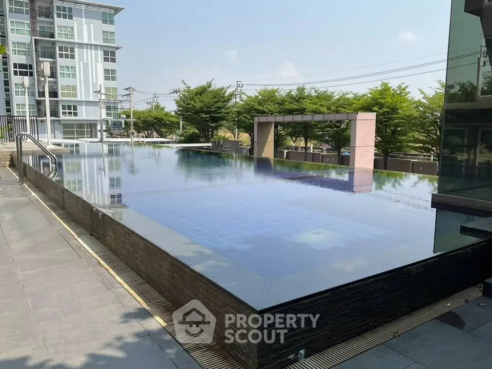 Luxurious condominium with stunning infinity pool and modern architecture.