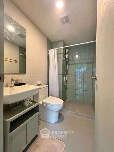 Modern bathroom with sleek shower and elegant fixtures in a contemporary apartment.
