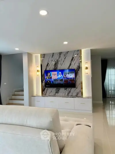 Luxurious living room with modern marble TV wall and elegant lighting