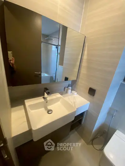 Modern bathroom with sleek sink and mirror in contemporary apartment