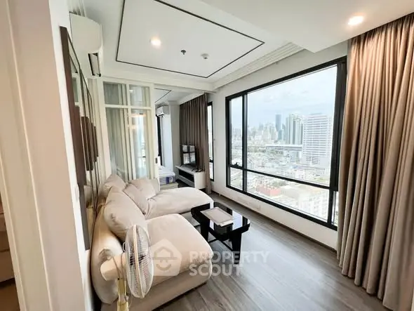 Spacious living room with panoramic city view and modern decor