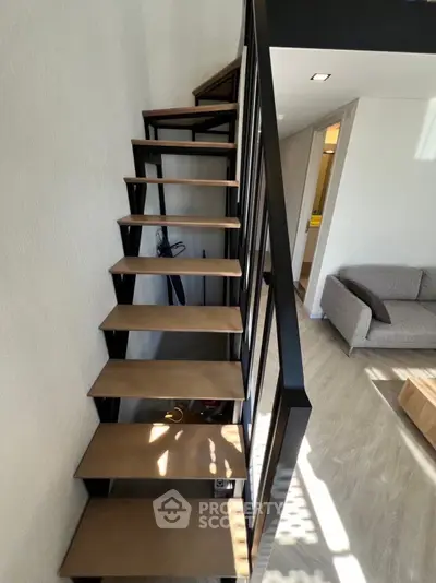 Modern interior with stylish staircase and cozy living area, perfect for urban living.