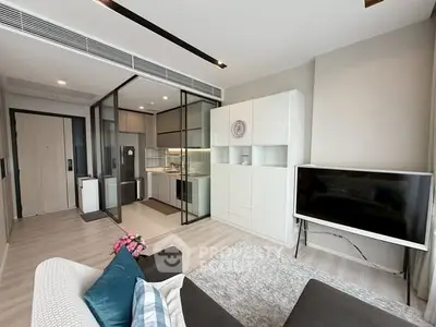 Modern living room with open kitchen layout and stylish decor