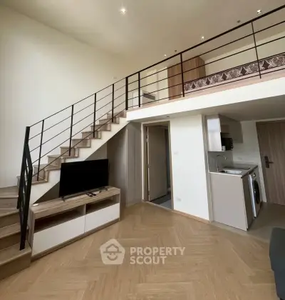Modern loft apartment with mezzanine, stylish staircase, and open kitchen layout.