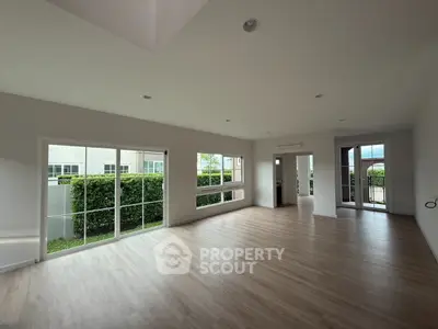 Spacious modern living room with large windows and garden view