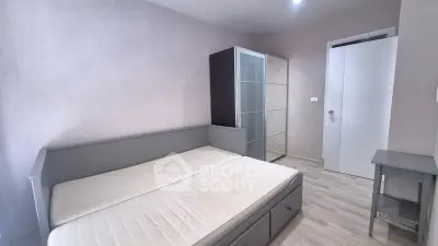 Modern minimalist bedroom with sleek furniture and neutral tones, perfect for a cozy living space.