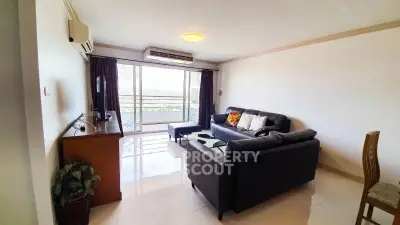 Spacious living room with modern furniture and balcony view in a stylish apartment.