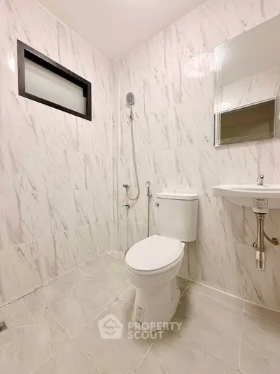 Modern bathroom with sleek marble tiles and minimalist fixtures