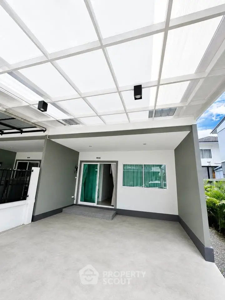 Modern home entrance with sleek design and covered patio, perfect for contemporary living.