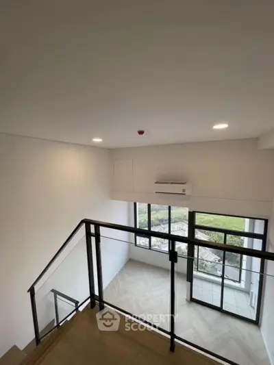 Modern duplex interior with large windows and sleek design