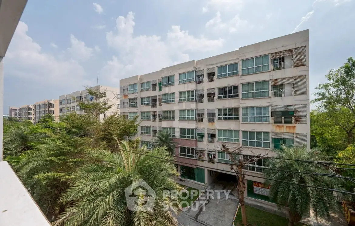 Spacious apartment building with lush greenery and modern design, perfect for urban living.