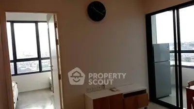 Modern apartment interior with large windows and balcony view