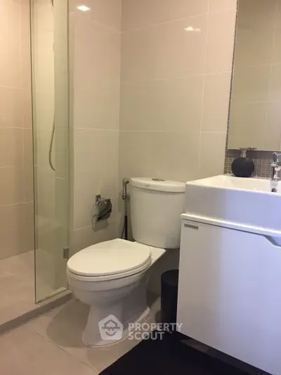 Modern bathroom with sleek fixtures and glass shower enclosure