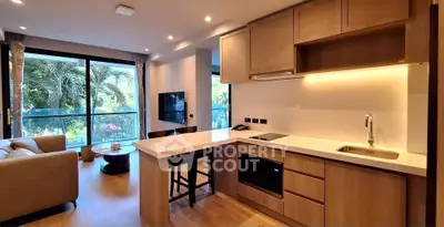 Modern open-plan living room with sleek kitchen and garden view.