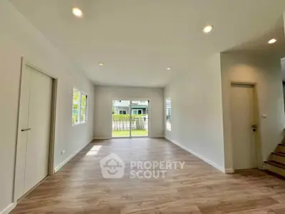 Spacious modern living room with wooden flooring and large windows