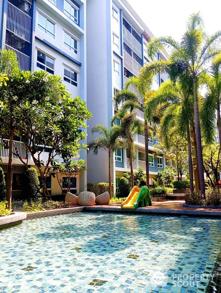 Modern condominium with pool and lush garden, perfect for family living.