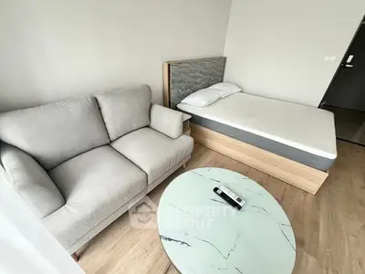 Modern studio apartment with cozy sofa and minimalist bed setup