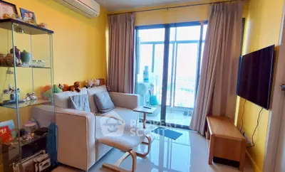 Cozy living room with bright yellow walls, modern furniture, and large window leading to a balcony.